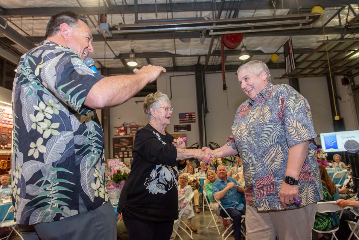 Three people, two shaking hands