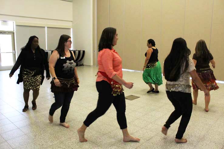 Staff practicing belly dancing