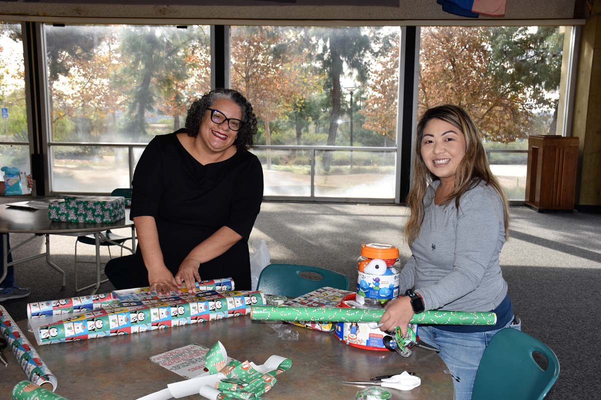 People enjoying the Holiday Wrap Party