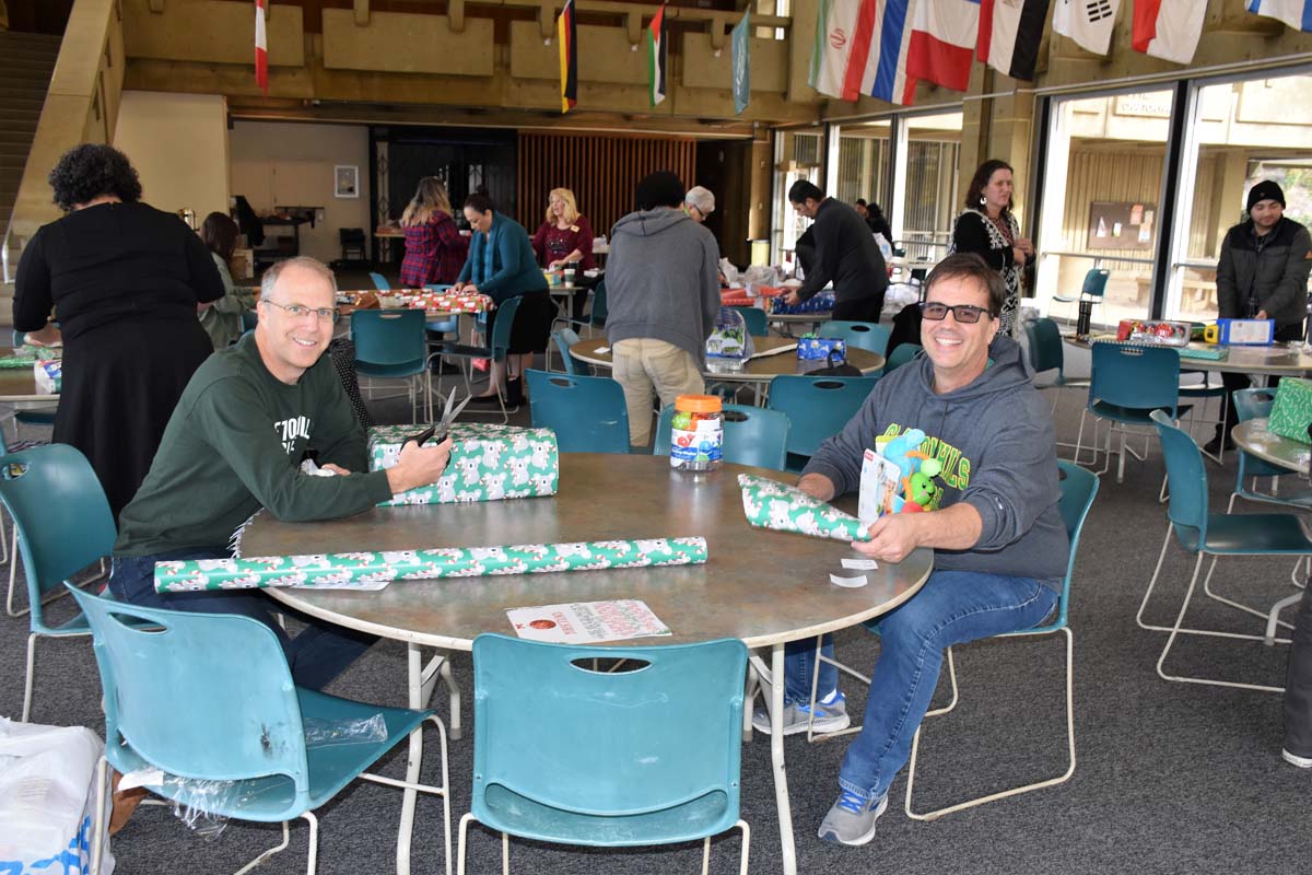 People enjoying the Holiday Wrap Party