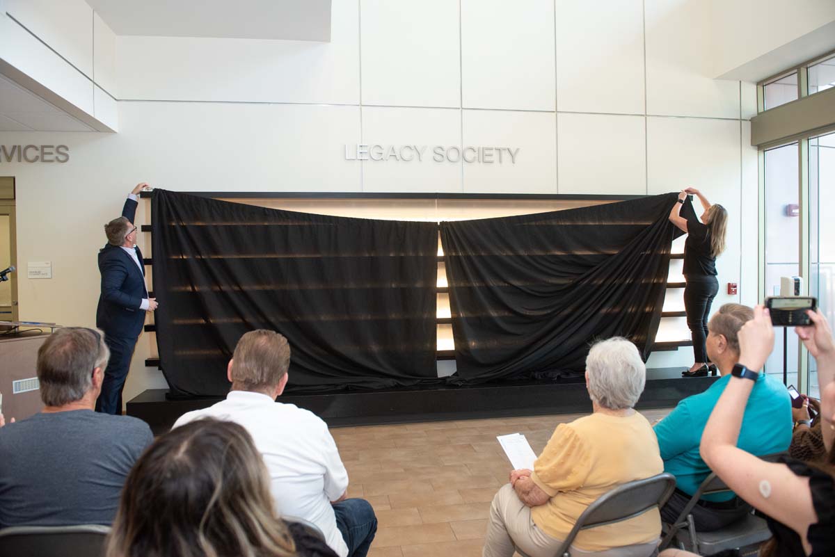People enjoying the Legacy Wall unveiling