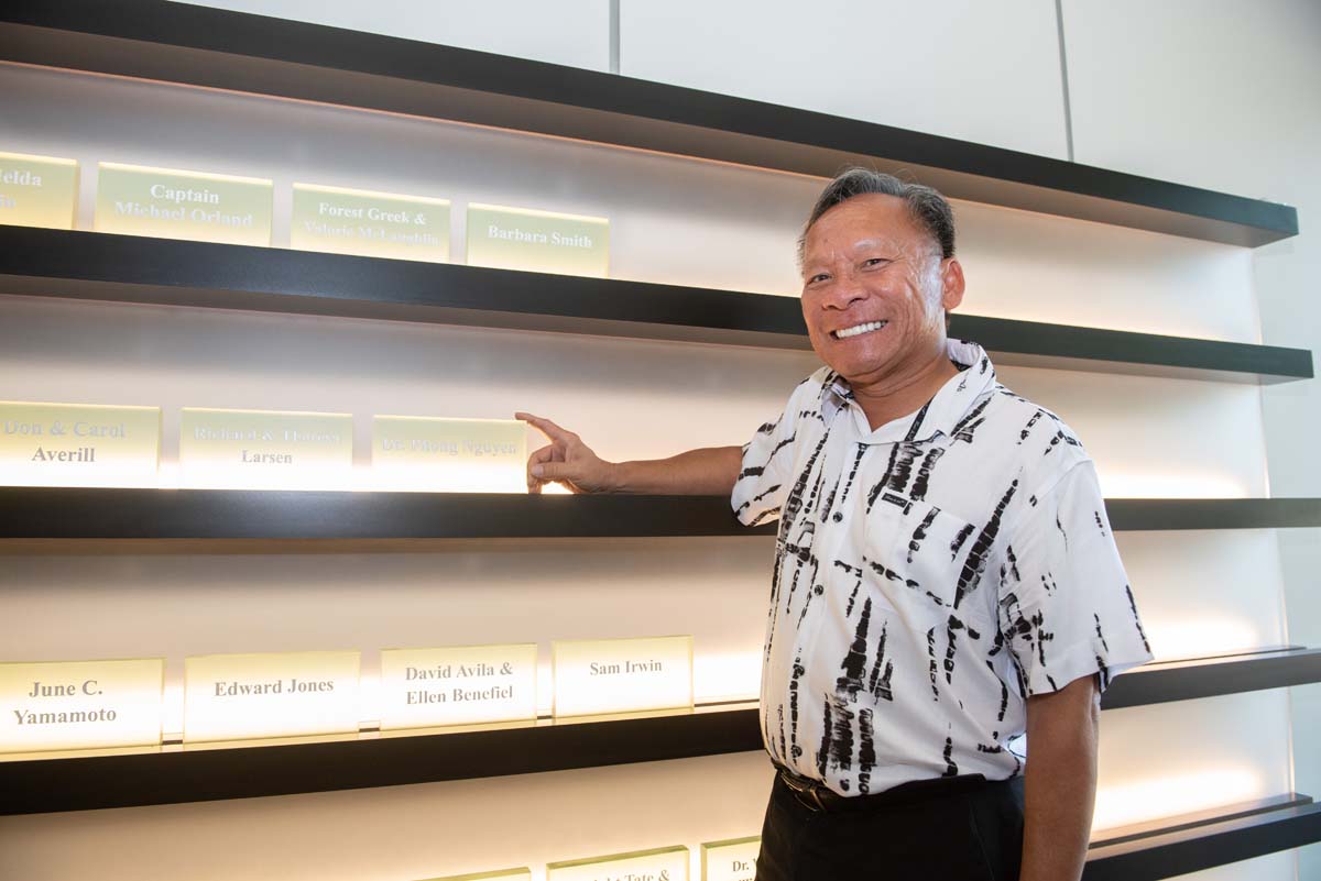 People enjoying the Legacy Wall unveiling