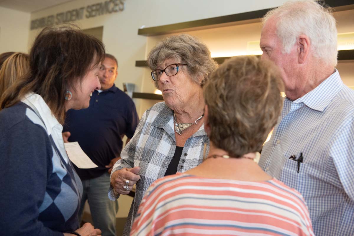 People enjoying the Legacy Wall unveiling