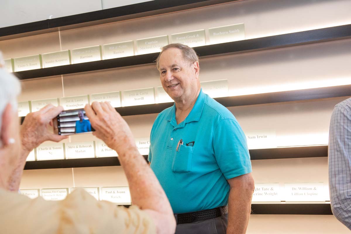 People enjoying the Legacy Wall unveiling