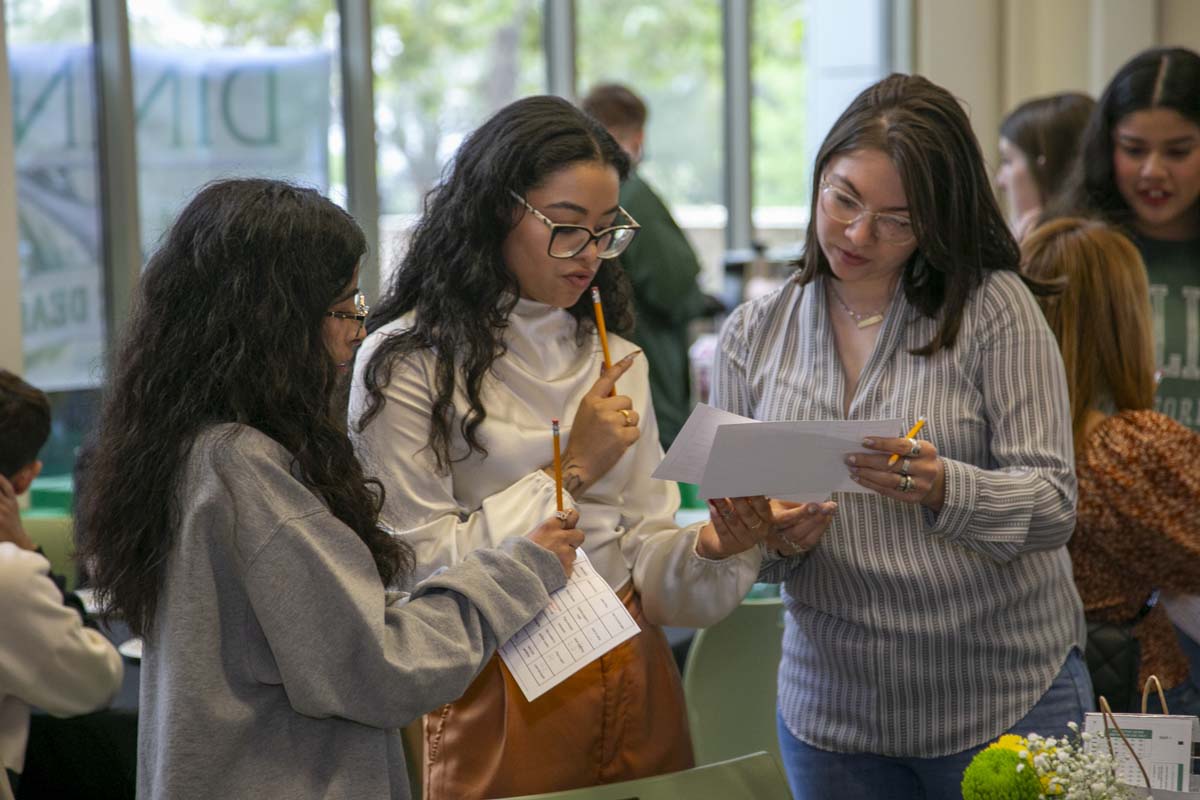 Students celebrate making deans list at event.