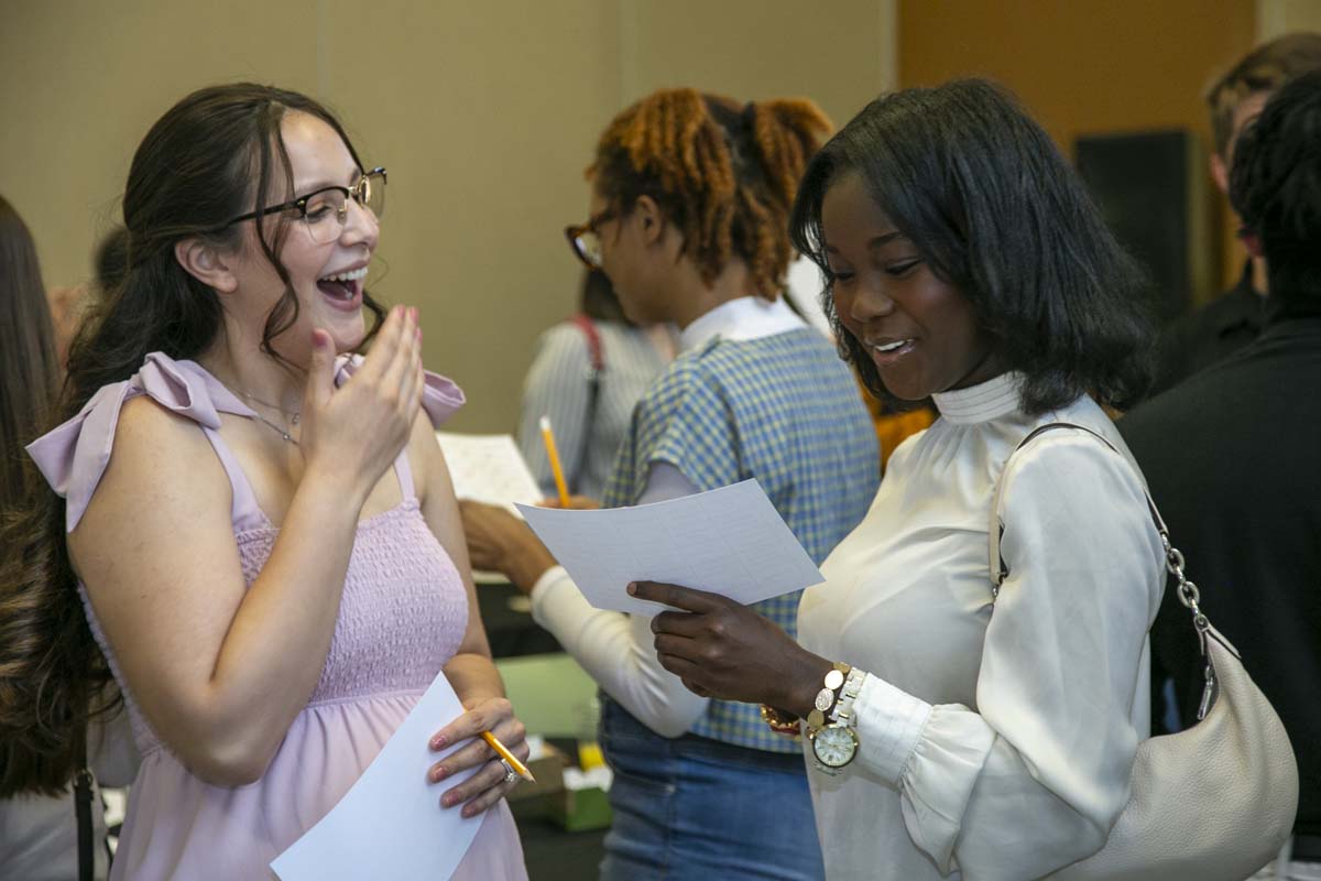 Students celebrate making deans list at event.