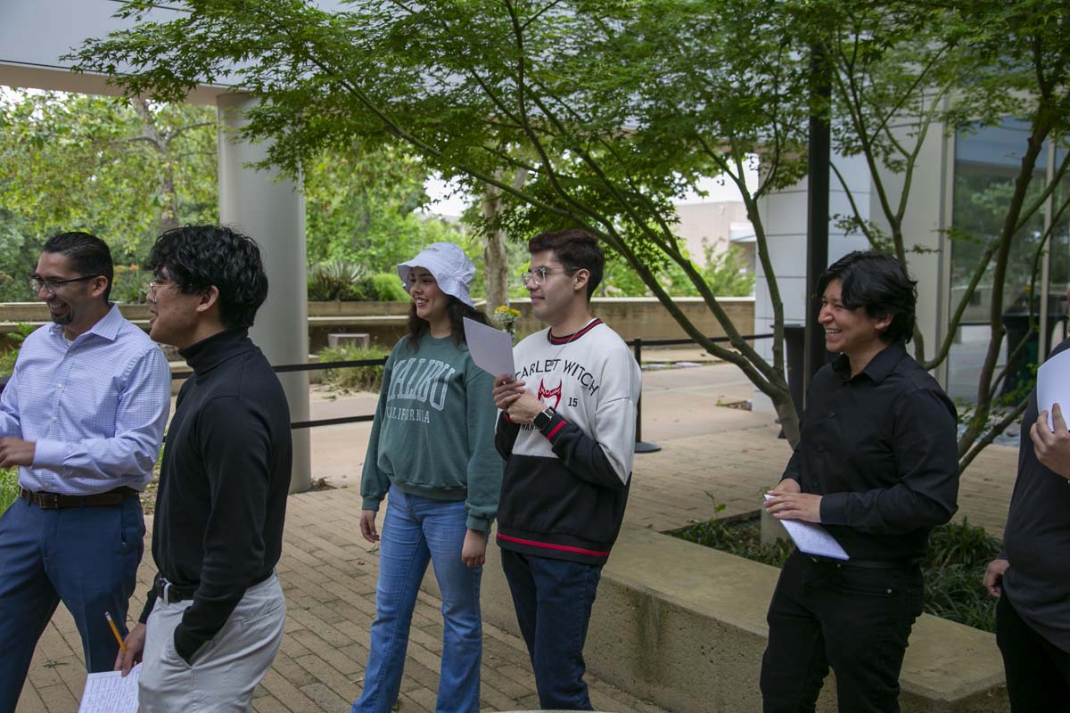 Students celebrate making deans list at event.