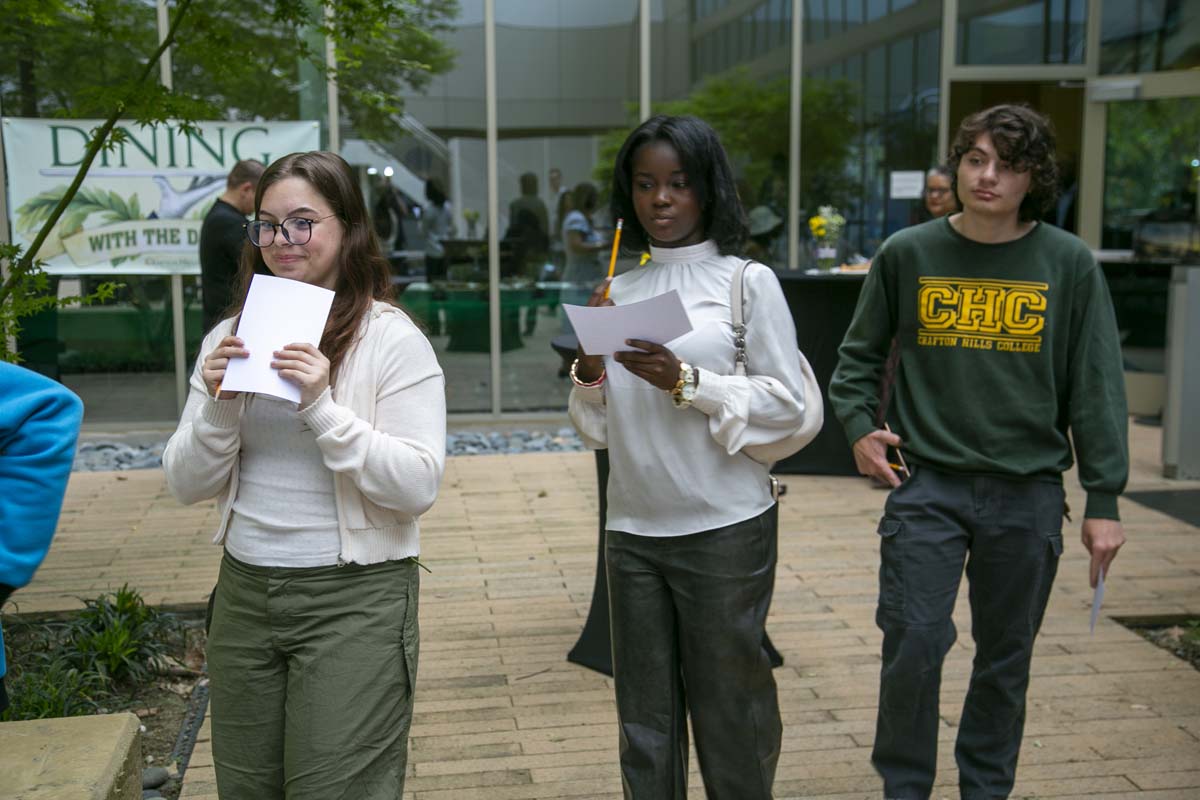 Students celebrate making deans list at event.