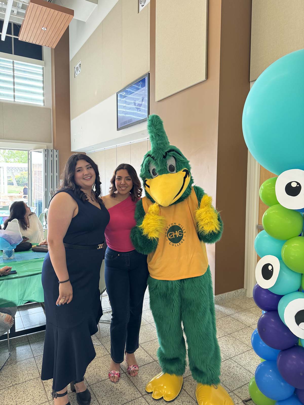 Students attend Transfer Dinner celebration with mascot Ryker.
