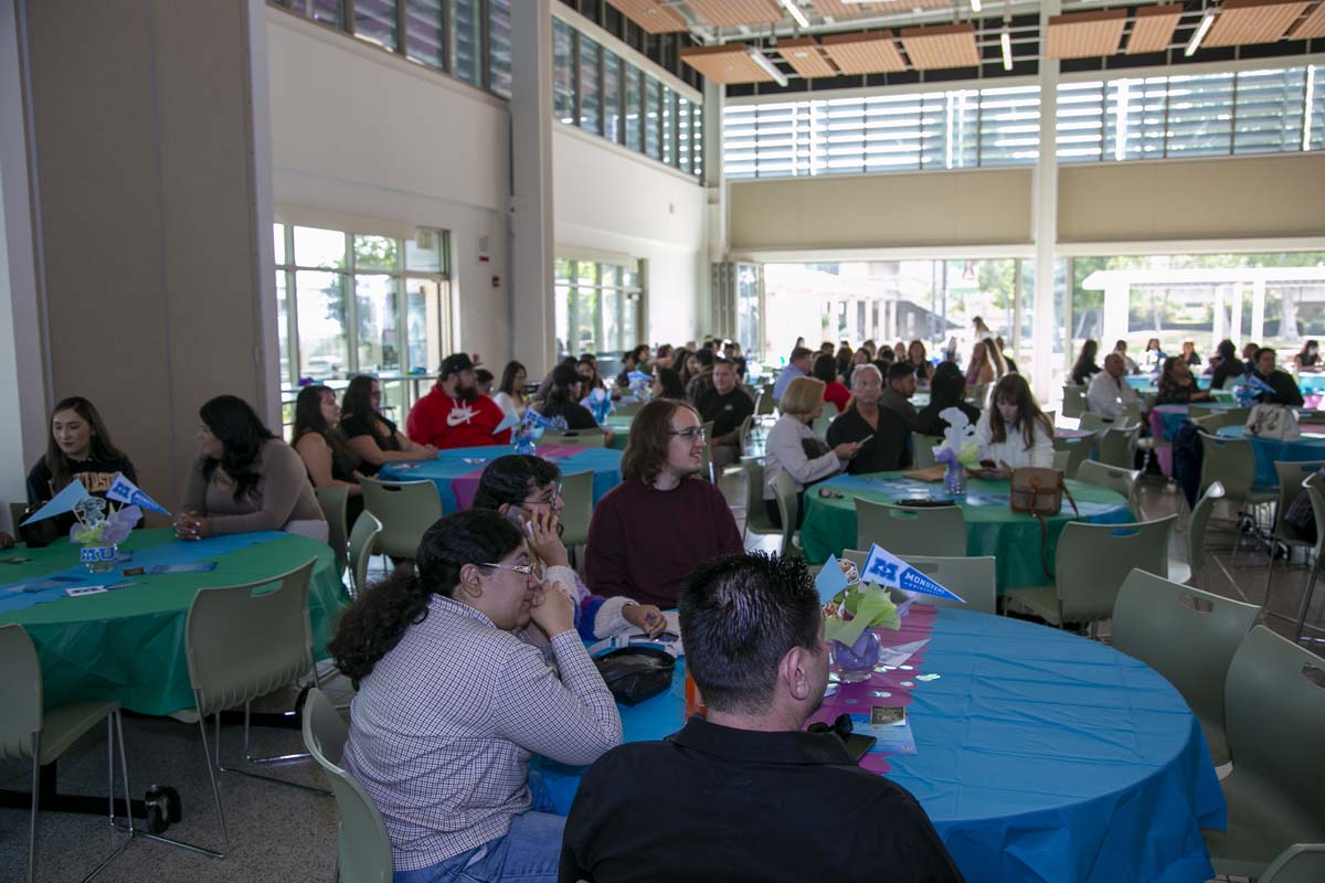 Students attend Transfer Dinner celebration with mascot Ryker.