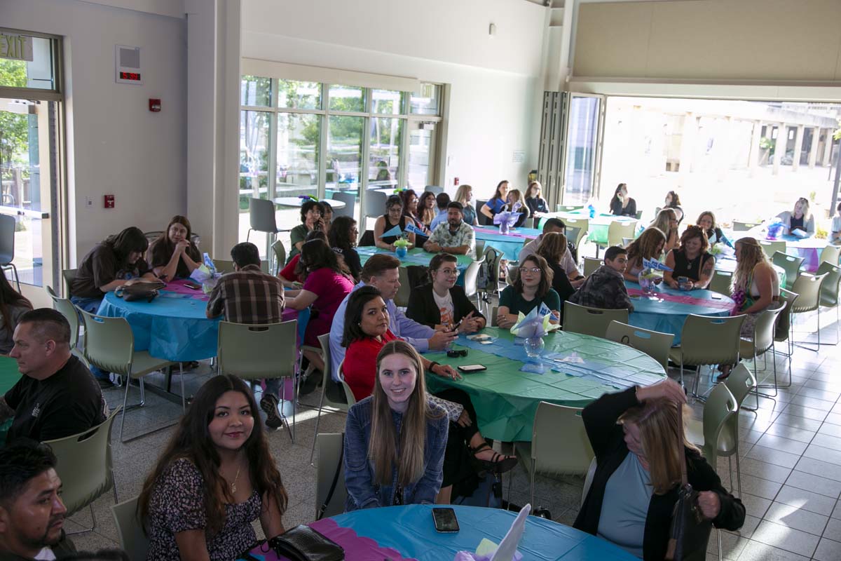 Students attend Transfer Dinner celebration with mascot Ryker.