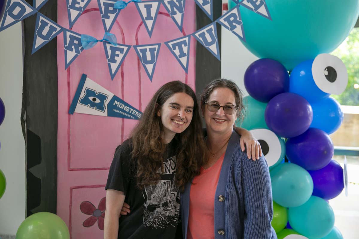 Students attend Transfer Dinner celebration with mascot Ryker.