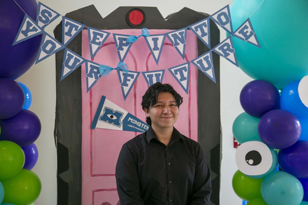 Students attend Transfer Dinner celebration with mascot Ryker.