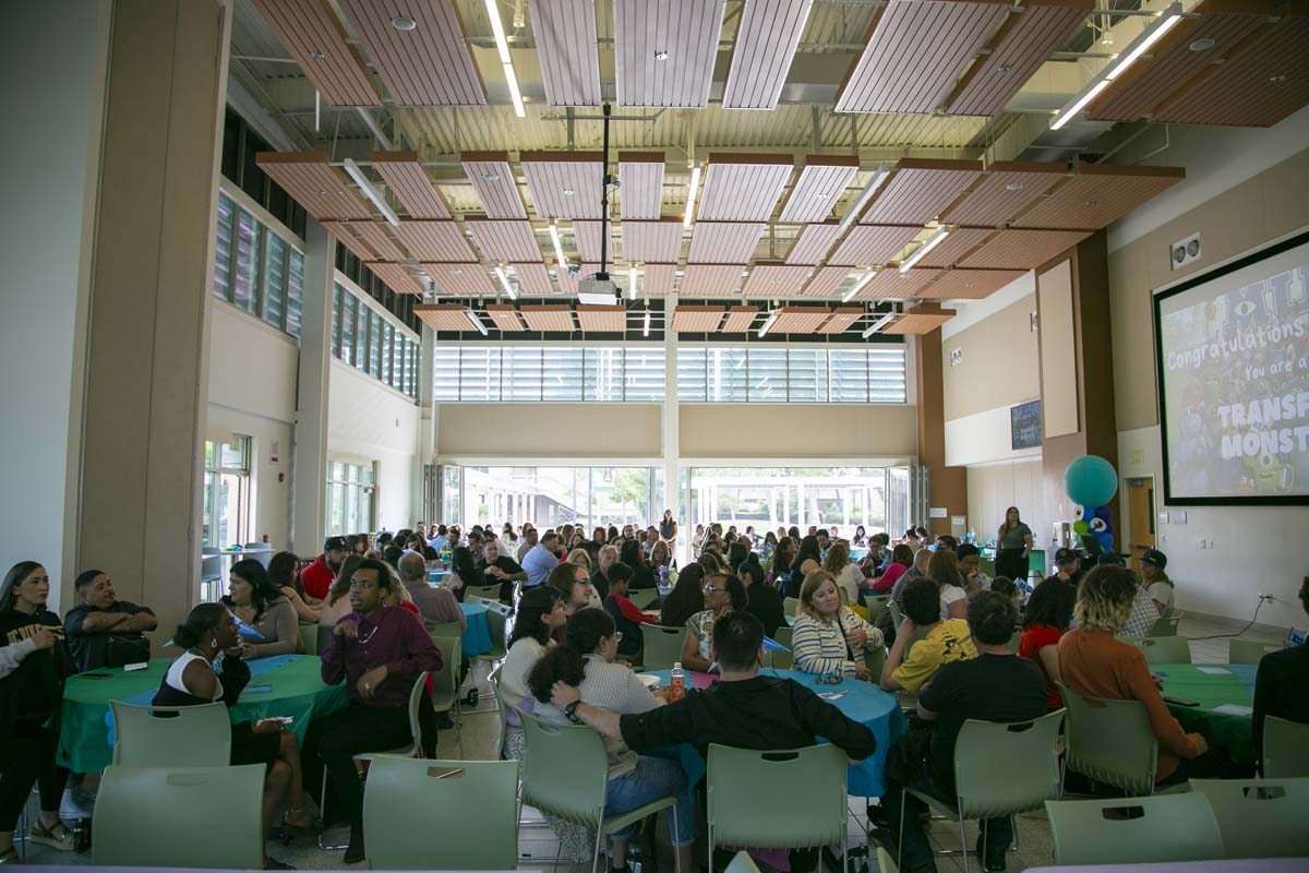 Students attend Transfer Dinner celebration with mascot Ryker.