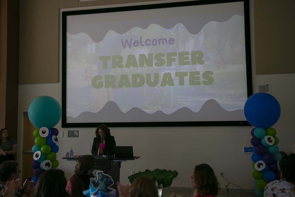 Students attend Transfer Dinner celebration with mascot Ryker.