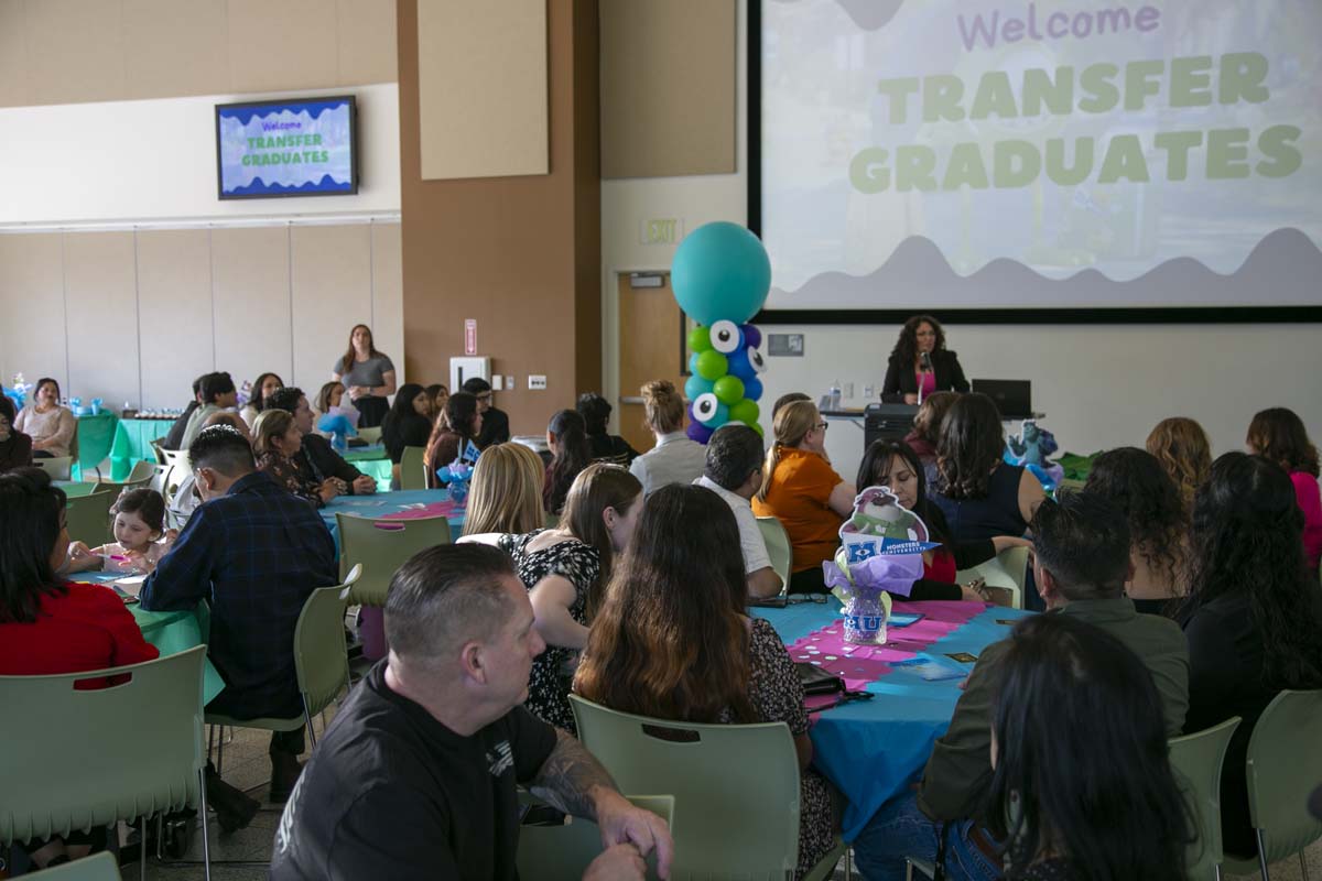 Students attend Transfer Dinner celebration with mascot Ryker.