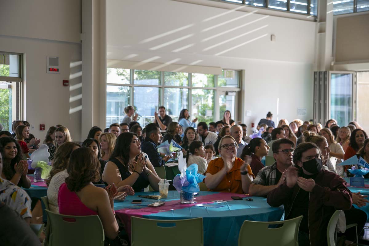 Students attend Transfer Dinner celebration with mascot Ryker.