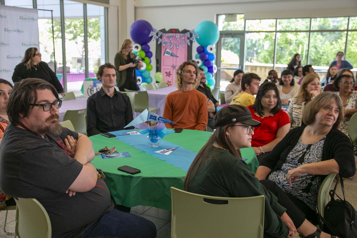 Students attend Transfer Dinner celebration with mascot Ryker.