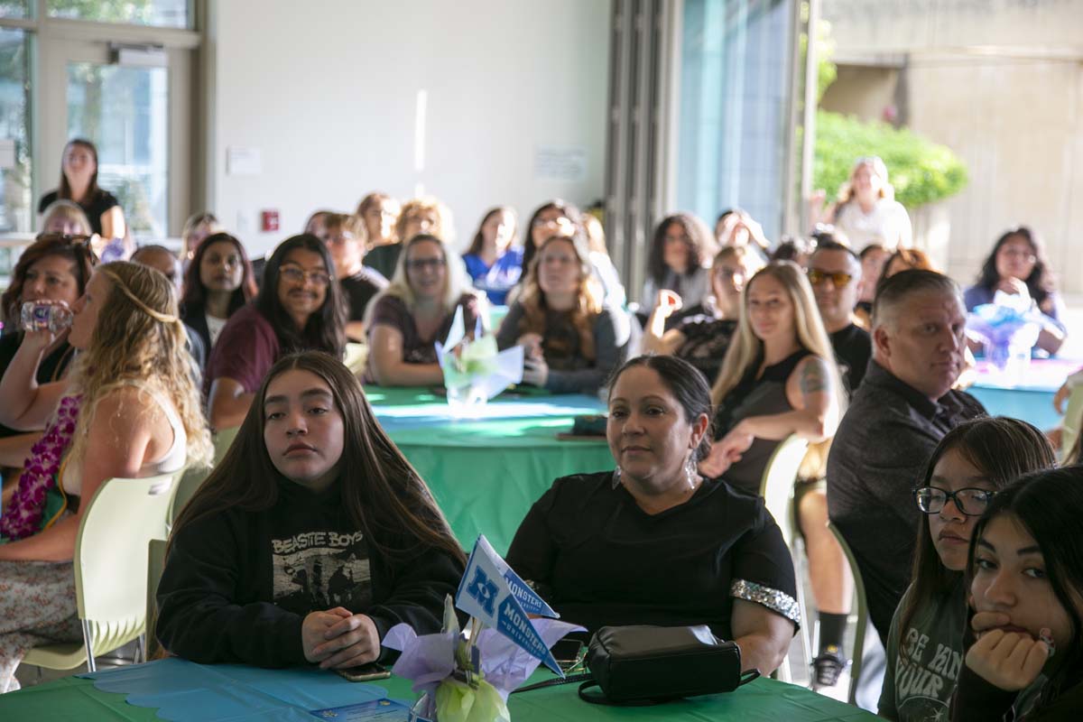 Students attend Transfer Dinner celebration with mascot Ryker.