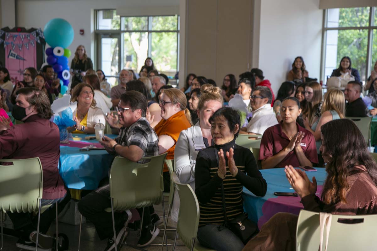 Students attend Transfer Dinner celebration with mascot Ryker.
