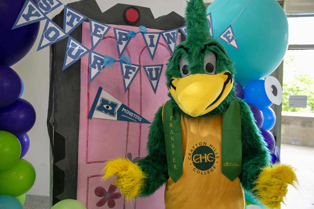 Students attend Transfer Dinner celebration with mascot Ryker.