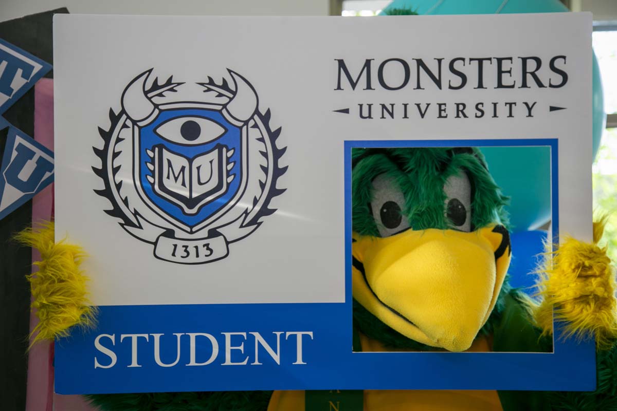 Students attend Transfer Dinner celebration with mascot Ryker.