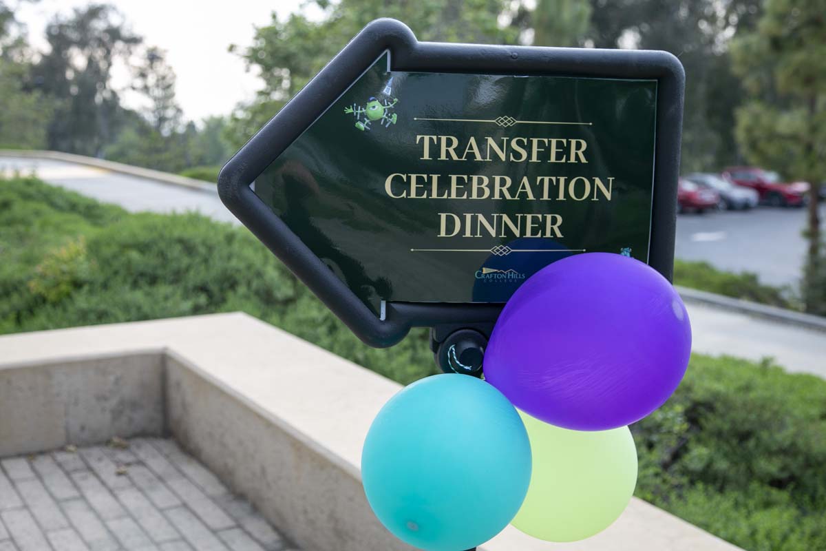 Students attend Transfer Dinner celebration with mascot Ryker.