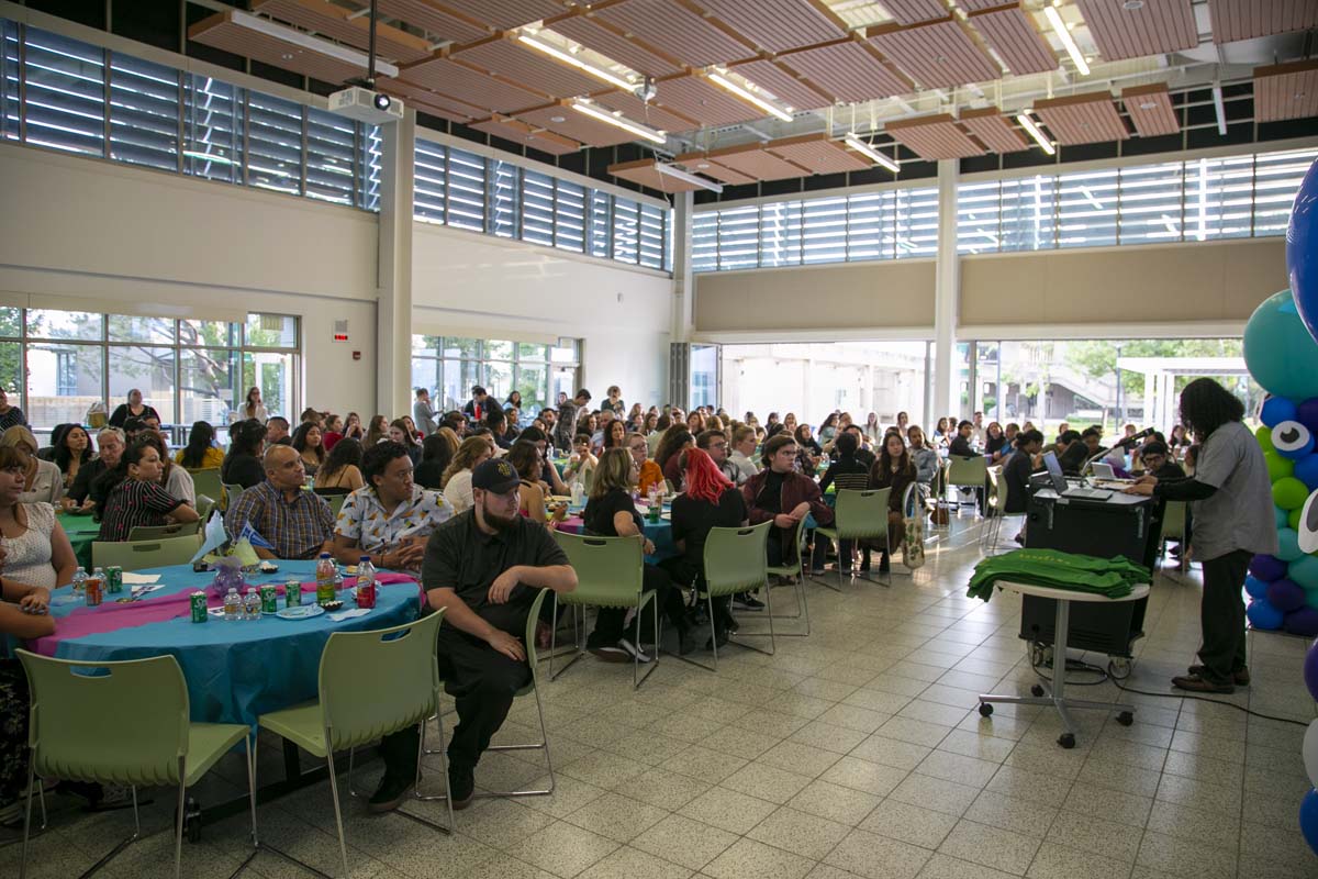 Students attend Transfer Dinner celebration with mascot Ryker.