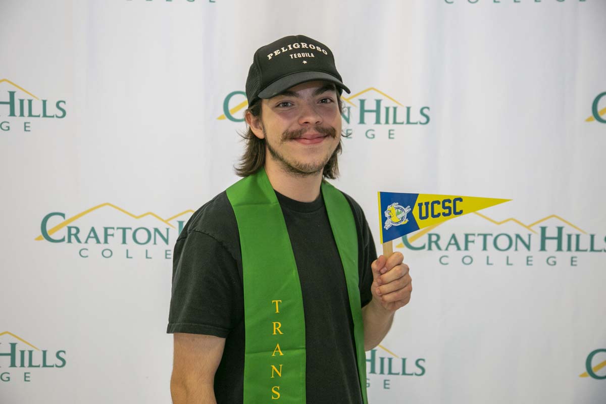 Students attend Transfer Dinner celebration with mascot Ryker.