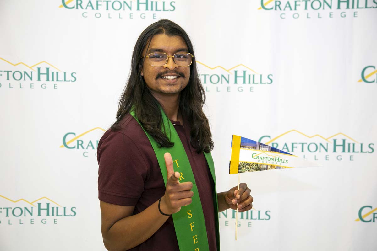 Students attend Transfer Dinner celebration with mascot Ryker.