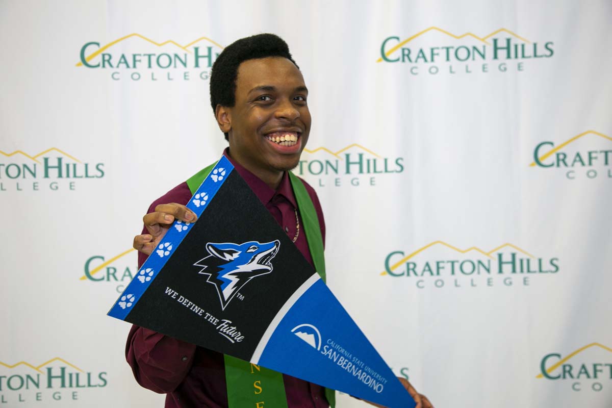 Students attend Transfer Dinner celebration with mascot Ryker.