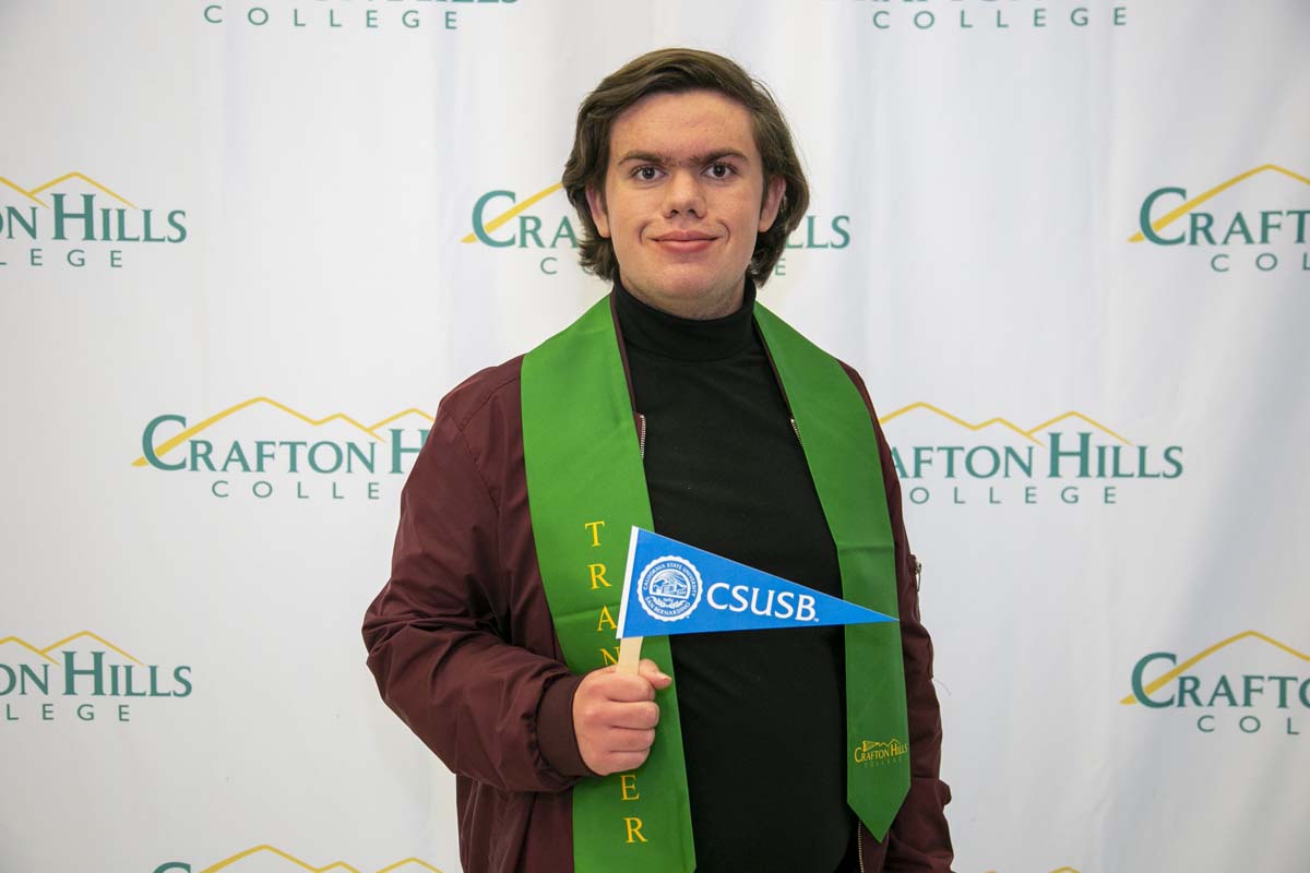 Students attend Transfer Dinner celebration with mascot Ryker.