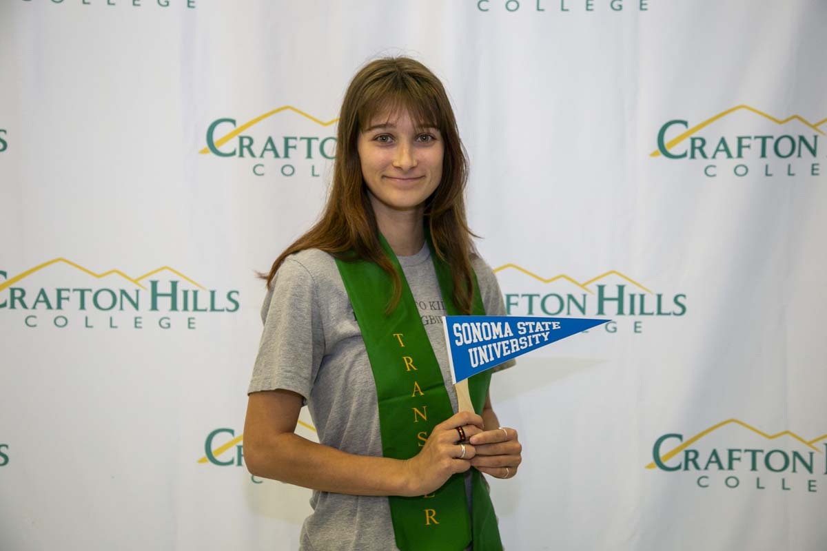 Students attend Transfer Dinner celebration with mascot Ryker.