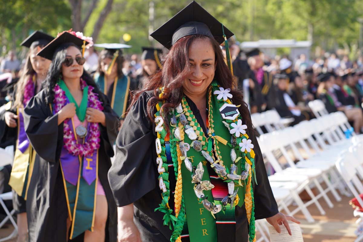 Graduates walk to stage at CHC's Commencement 2024.