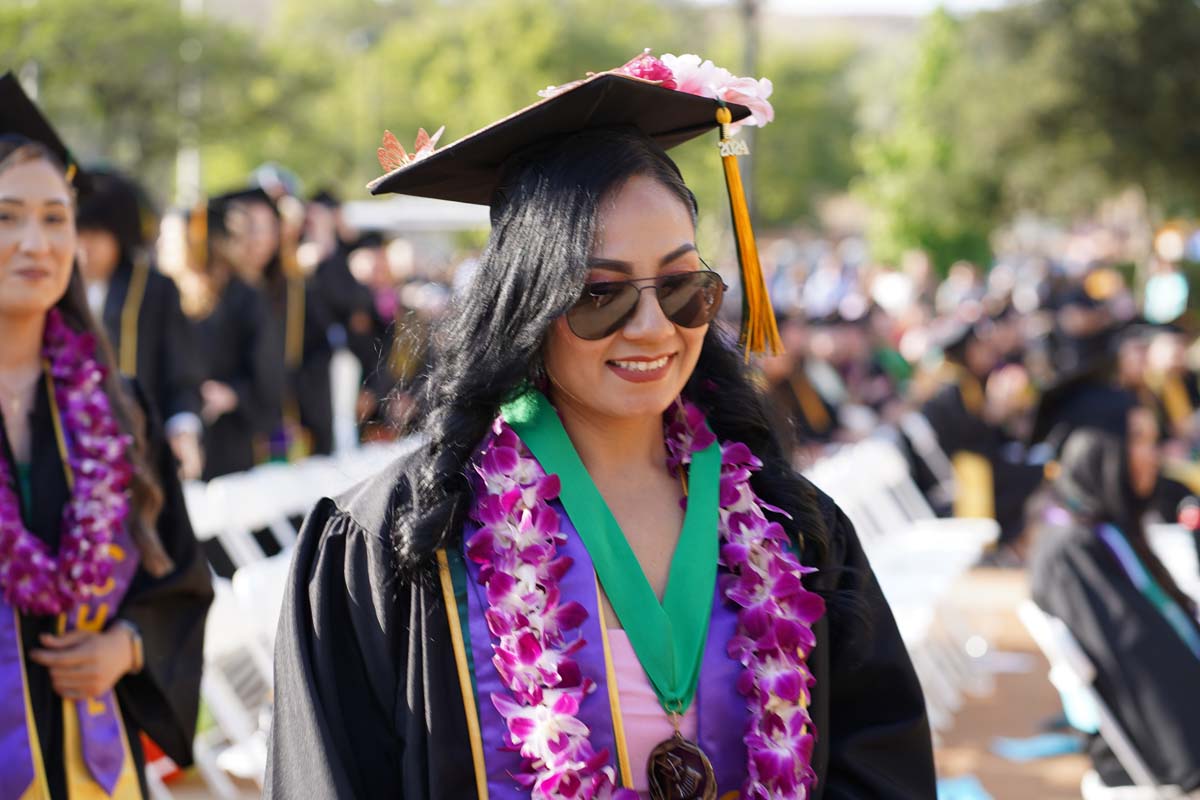 Graduates walk to stage at CHC's Commencement 2024.