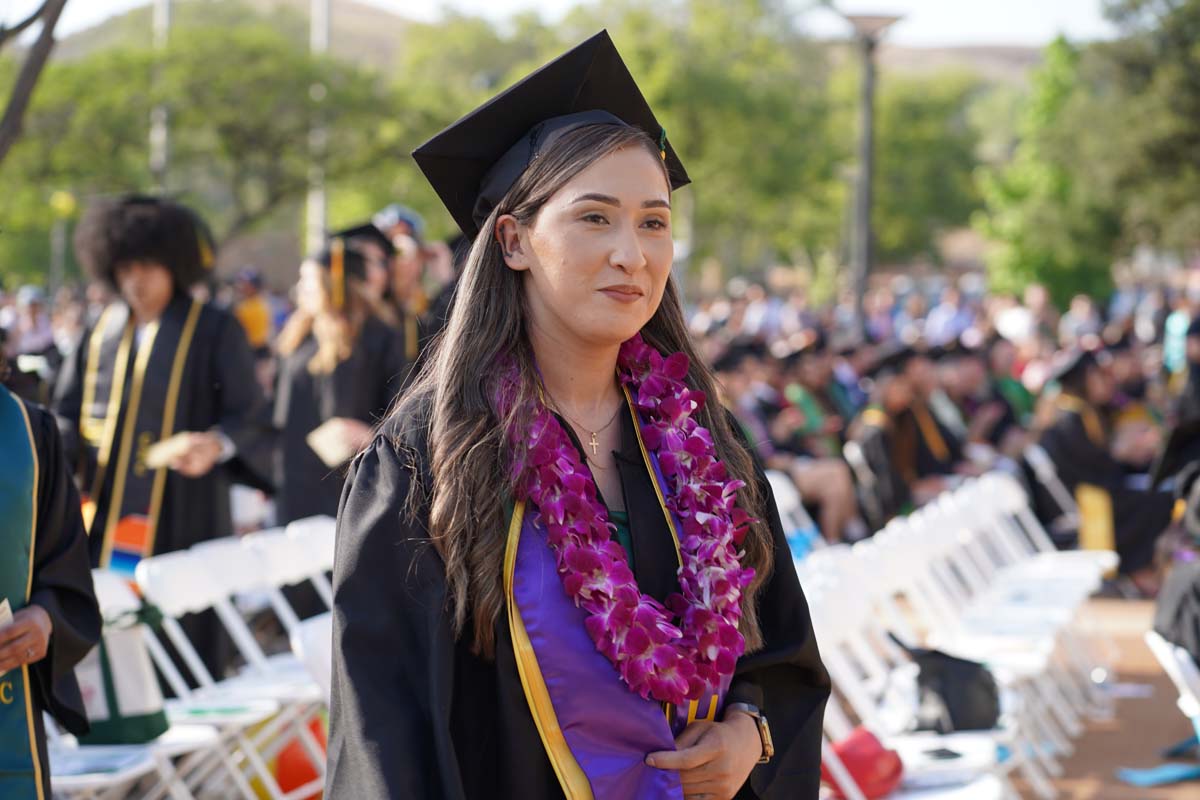 Graduates walk to stage at CHC's Commencement 2024.