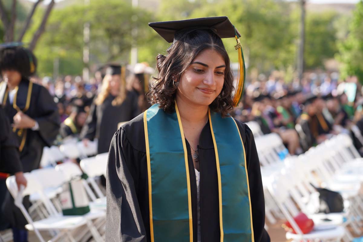 Graduates walk to stage at CHC's Commencement 2024.