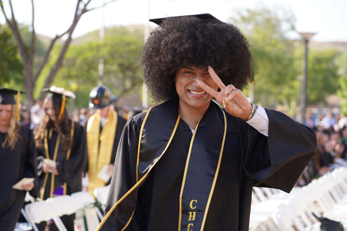 Graduates walk to stage at CHC's Commencement 2024.