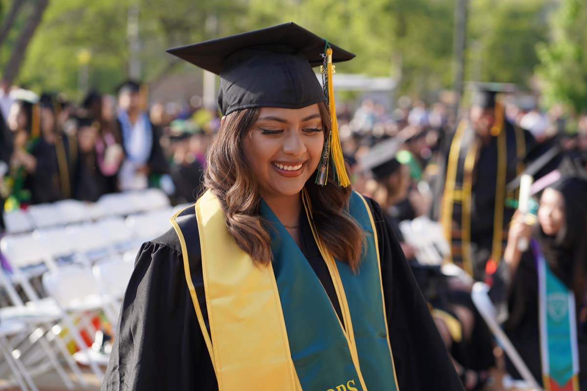 Graduates walk to stage at CHC's Commencement 2024.