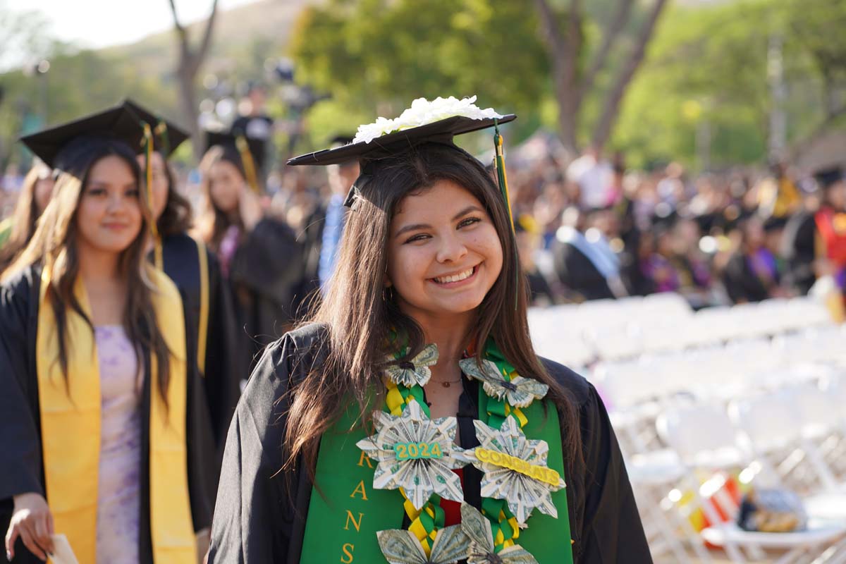 Graduates walk to stage at CHC's Commencement 2024.
