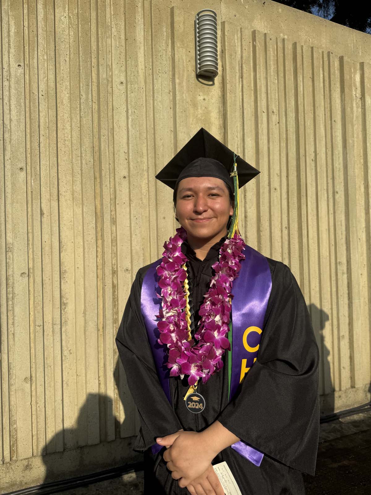 Graduates walk to stage at CHC's Commencement 2024.