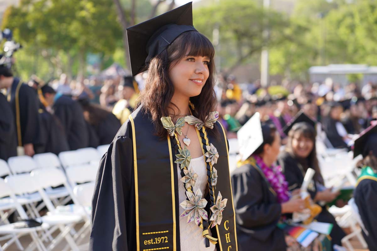 Graduates walk to stage at CHC's Commencement 2024.