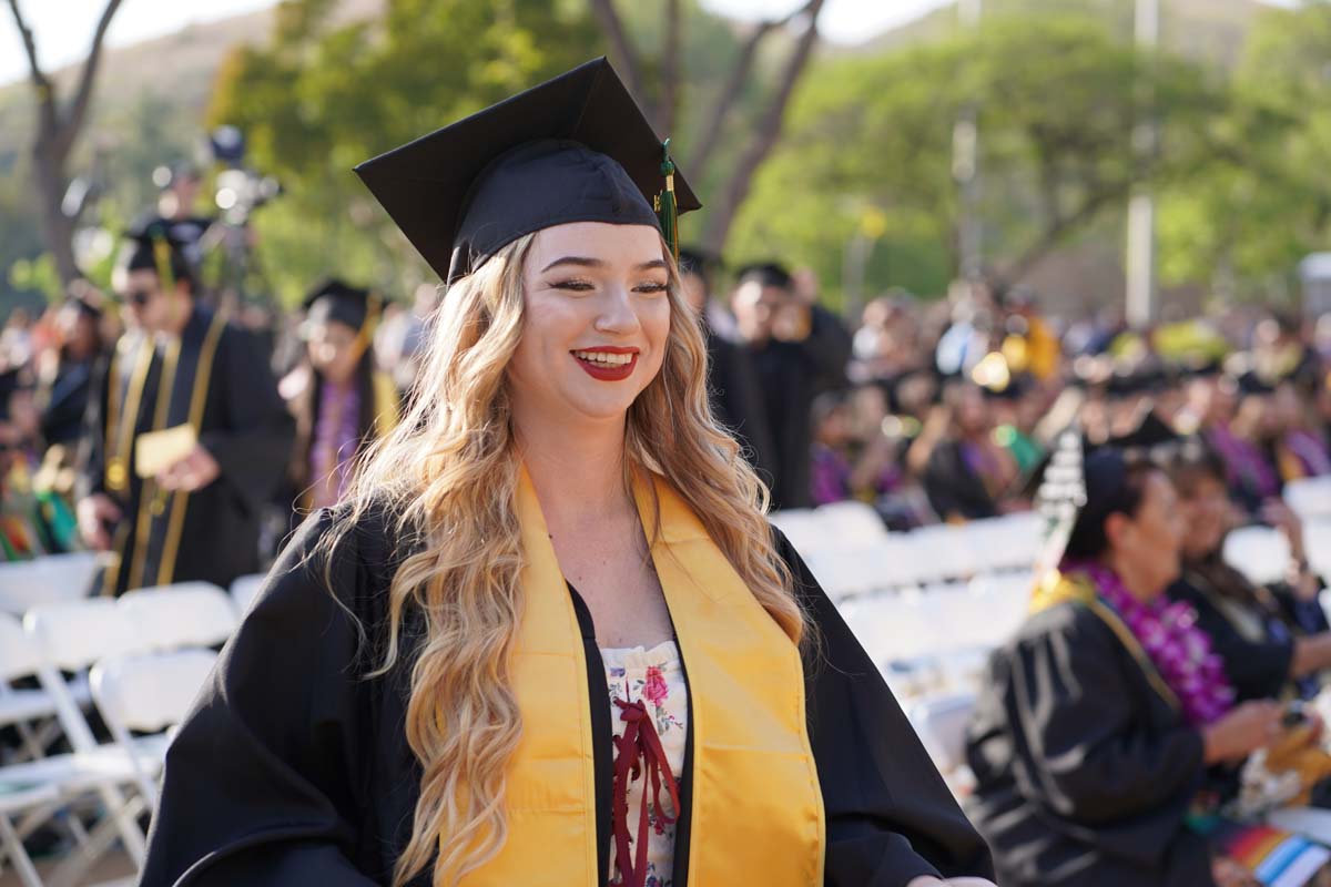 Graduates walk to stage at CHC's Commencement 2024.