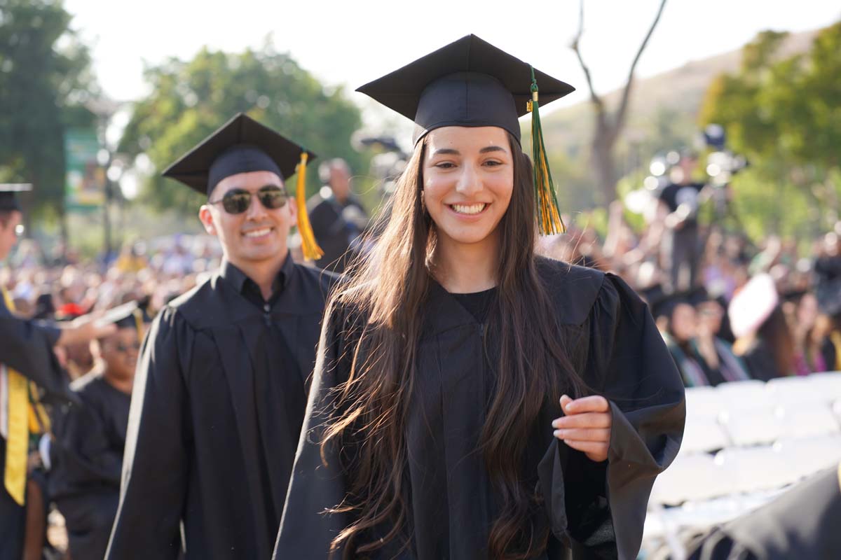 Graduates walk to stage at CHC's Commencement 2024.