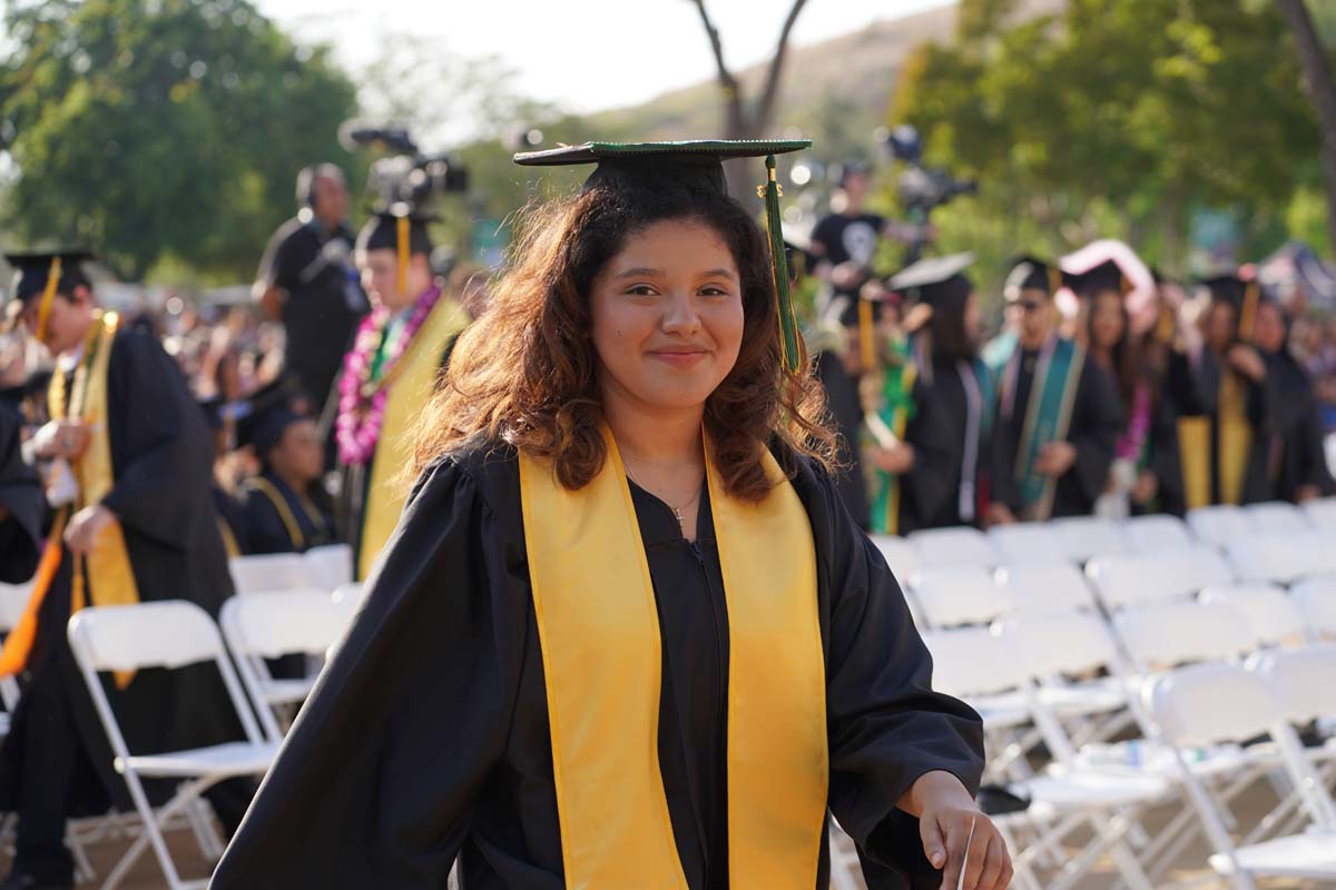 Graduates walk to stage at CHC's Commencement 2024.