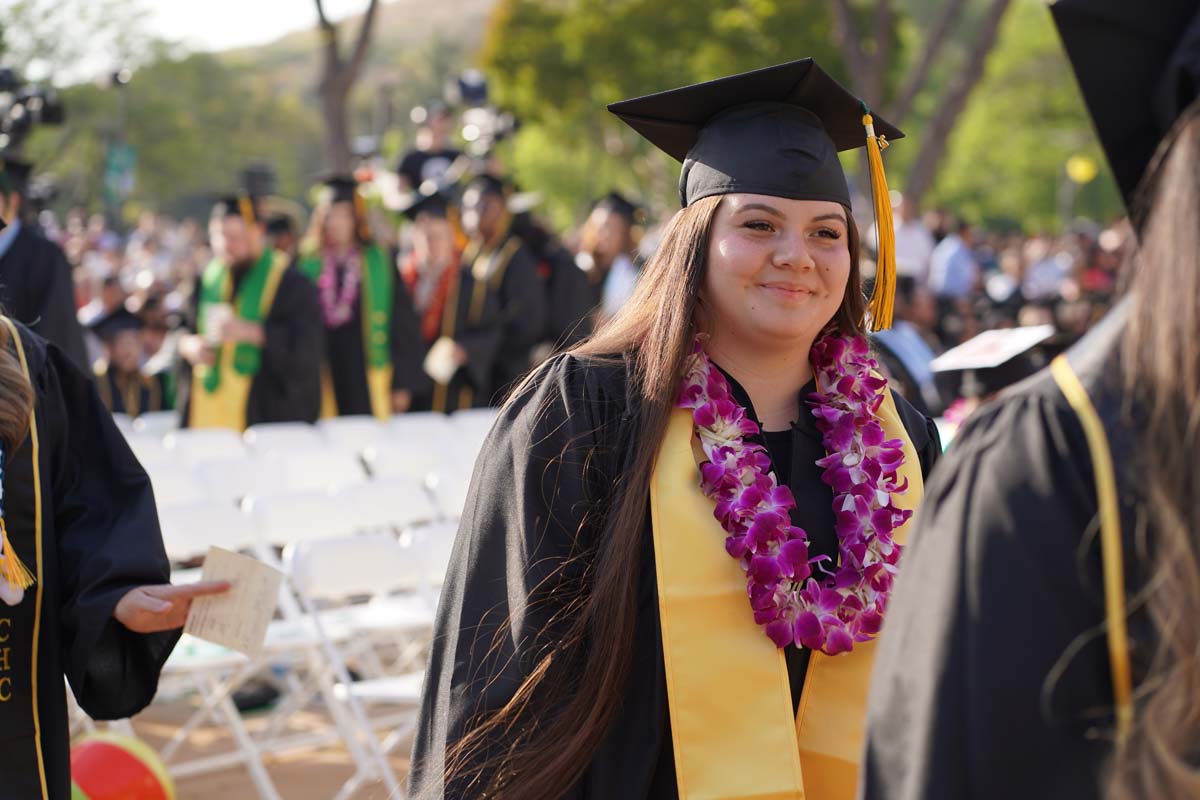 Graduates walk to stage at CHC's Commencement 2024.