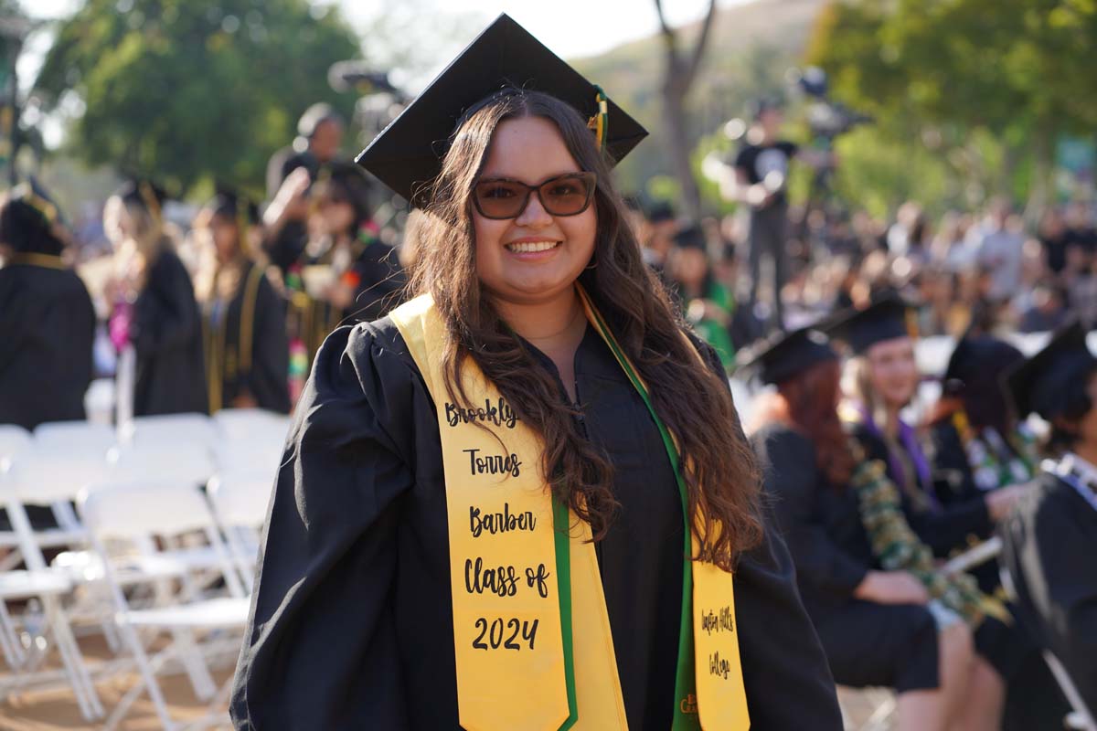 Graduates walk to stage at CHC's Commencement 2024.