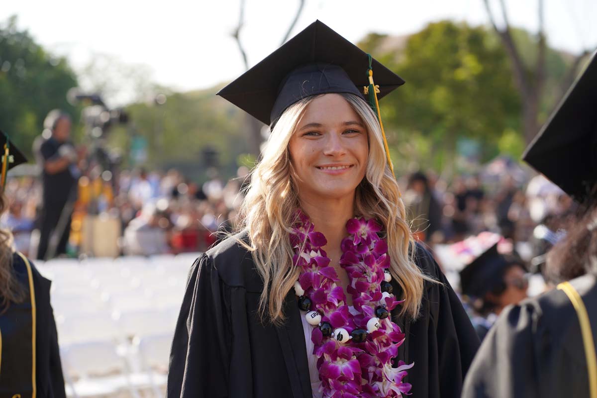 Graduates walk to stage at CHC's Commencement 2024.