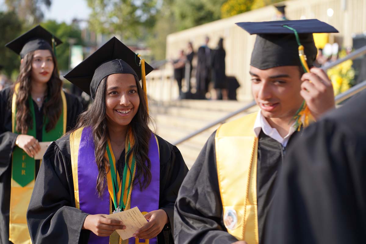 Graduates walk to stage at CHC's Commencement 2024.