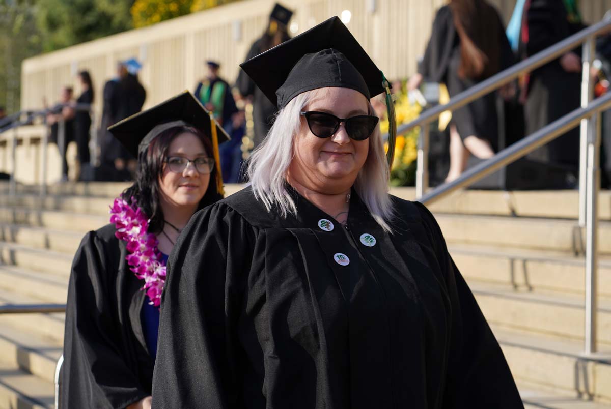 Graduates walk to stage at CHC's Commencement 2024.